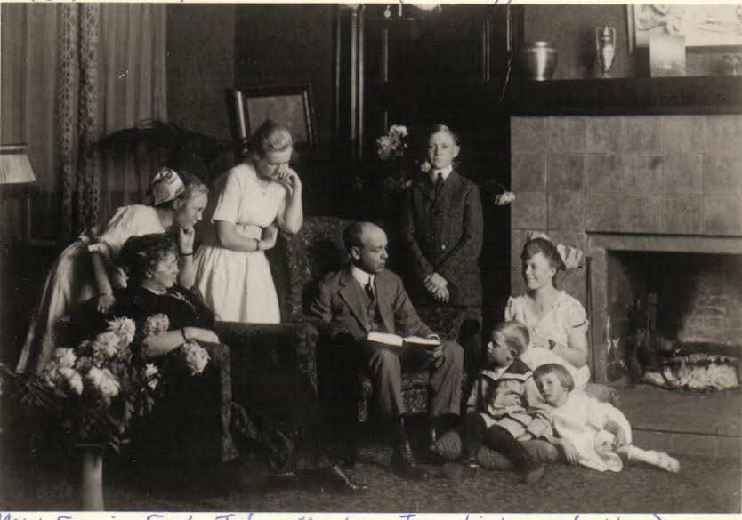 Frederick L. Linderman seated and reading to members of his family